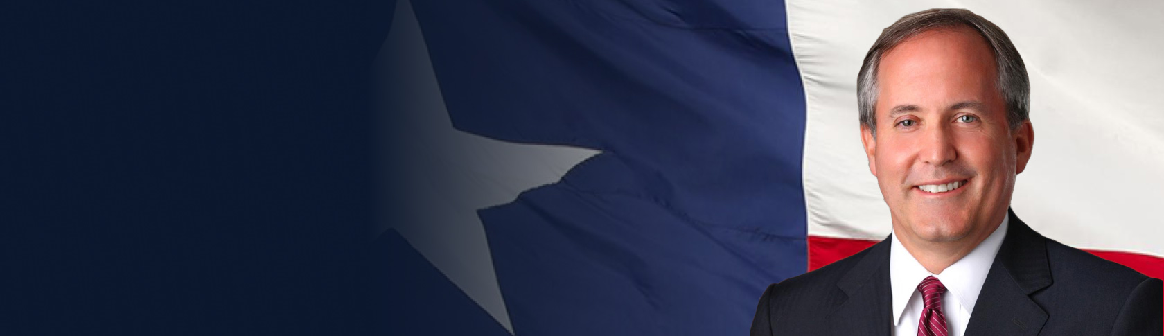 Ken Paxton in front of the Texas flag. 